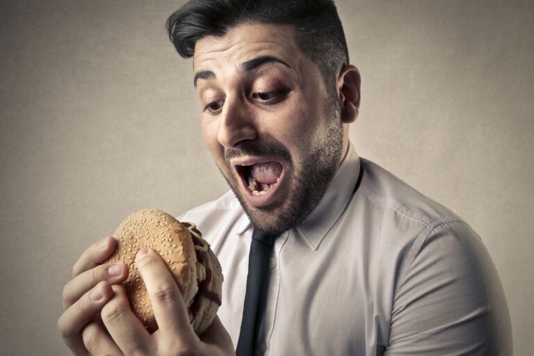 Hombre comiendo una hamburguesa