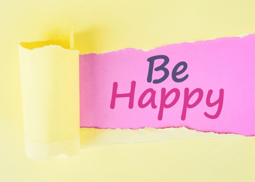 Cartulina con texto "be happy" (ser feliz en español)